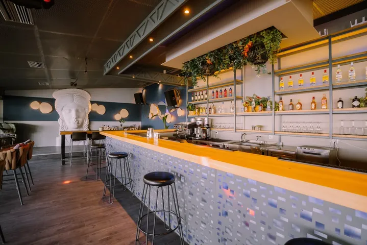 Main bar counter at Sirius Samos with premium spirits and modern design